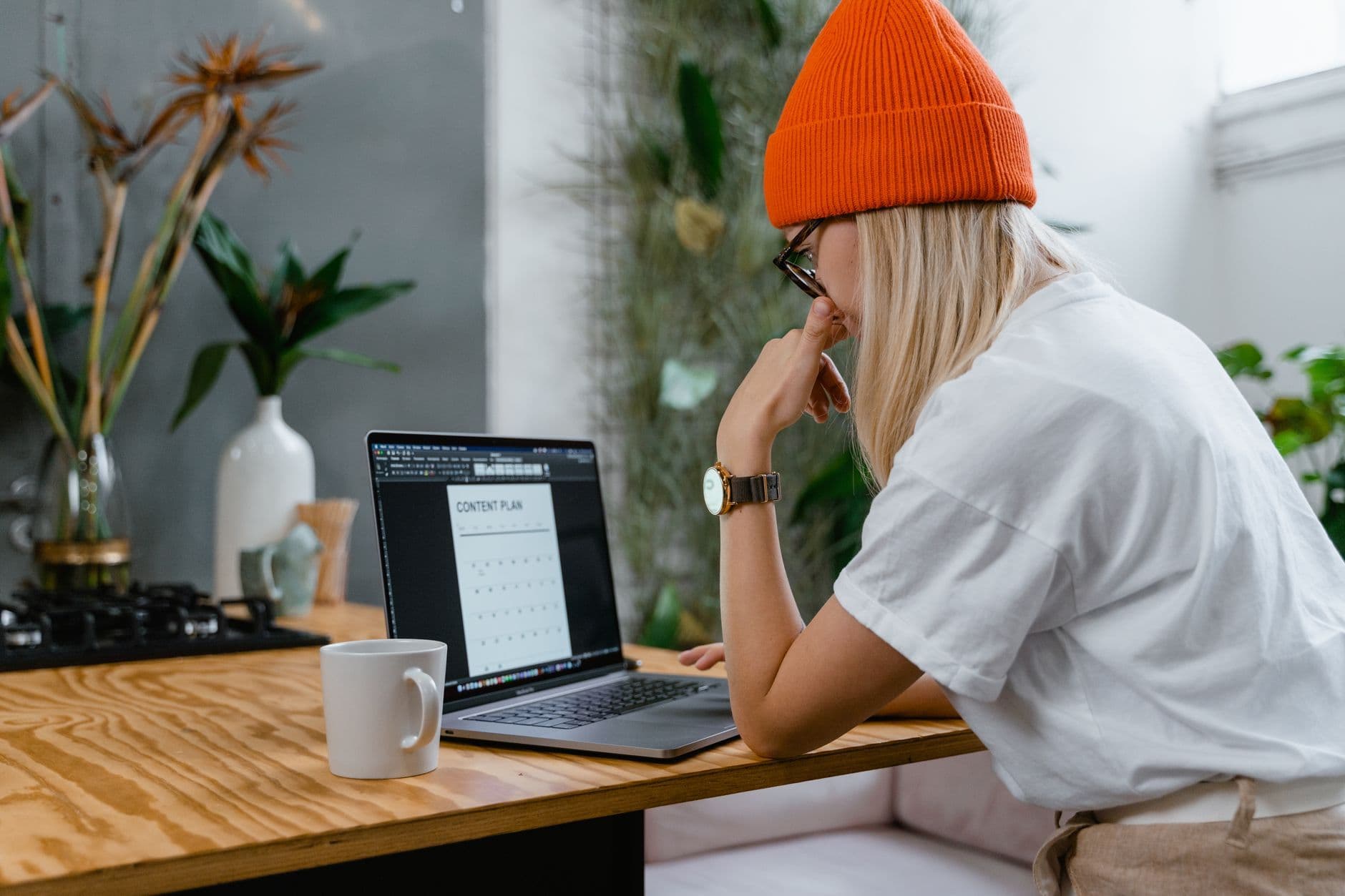 Small business owner planning website content on a laptop in a home office